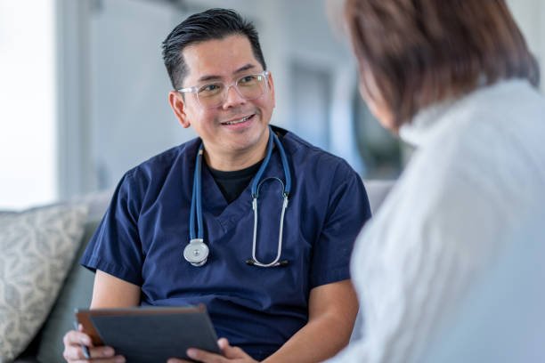 Home health caregiver assisting a senior patient during a homecare appointment